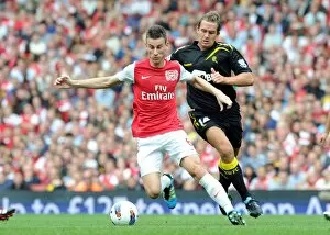Arsenal v Bolton Wanderers 2011-12 Collection: Laurent Koscielny (Arsenal) Kevin Davies (Bolton). Arsenal 3: 0 Bolton Wanderers
