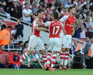 Arsenal v Crystal Palace 2014/15 Collection: Laurent Koscielny celebrates scoring Arsenals 1st goal with Alexis Sanchez. Arsenal 2
