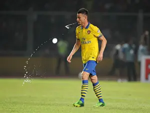 Indonesia Dream Team V Arsenal 2013-14 Prints: Laurent Koscielny Faces Off Against Indonesia All-Stars in 2013
