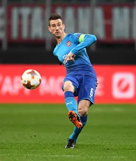 AC Milan V Arsenal 2017-18 Prints: Laurent Koscielny Focuses in AC Milan vs Arsenal Europa League Clash