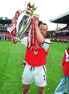 Lee Dixon (Arsenal) lifts the F. A. Barclaycard Premiership Trophy