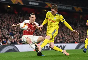 Arsenal V BATE Borisov 2018-19 Prints: Lichtsteiner vs Filipovic: A Europa League Battle at Arsenal's Emirates Stadium