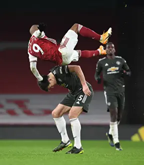 LONDON, ENGLAND - JANUARY 30: Alex Lacazette of Arsenal challenged by Harry Maguire of Man United during the Premier