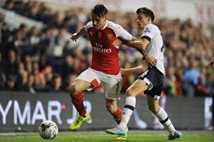 Tottenham Hotspur v Arsenal Capital One Cup 2015/16 Collection: London Rivalry: Debuchy vs. Carroll in the Capital One Cup Clash (Tottenham Hotspur vs)