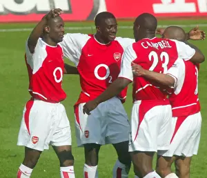 (L>R) Lauren, Kolo Toure, Sol Campbell and Ashley Cole celebrate at the end of the match
