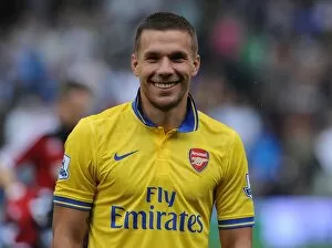 Images Dated 24th August 2013: Lukas Podolski: Arsenal Star's Focus Before Fulham Clash (2013-14)