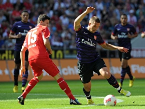 Lukas Podolski (Arsenal) Tobias Strobl (Cologne). Cologne 0:4 Arsenal. Pre Season Friendly Lukas Podolski (Arsenal) Tobias Strobl (Cologne). Cologne 0:4 Arsenal. Pre Season Friendly
