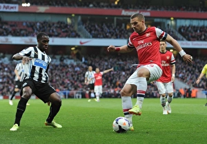 Arsenal v Newcastle United 2013/14 Gallery: Lukas Podolski (Arsenal) Vurnon Anita (Newcastle). Arsenal 2: 0 Newcastle United