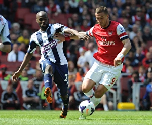 Arsenal v West Bromwich Albion 2013-14 Gallery: Lukas Podolski (Arsenal) Yousouf Mulumbu (WBA). Arsenal 1: 0 West Bromwich Albion