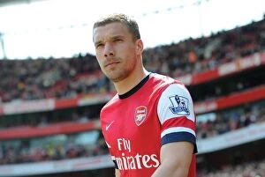 Arsenal v West Bromwich Albion 2013-14 Collection: Lukas Podolski: Arsenal's Ready-to-Go Warrior Against West Bromwich Albion (2013-14)