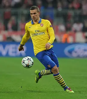 Bayern Munich V Arsenal 2013-14 Prints: Lukas Podolski: Battle at the Allianz Arena - FC Bayern Munich vs Arsenal