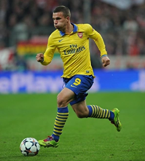 Bayern Munich V Arsenal 2013-14 Prints: Lukas Podolski: Battle in Munich - Arsenal vs