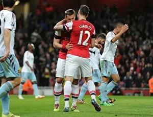 Arsenal v West Ham United 2013/14 Collection: Lukas Podolski celebrates scoring his and Arsenals 1st goal with Olivier Giroud
