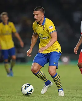 Indonesia Dream Team V Arsenal 2013-14 Prints: Lukas Podolski Faces Off Against Indonesia All-Stars in 2013-14