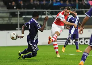 Lukas Podolski Scores Against Chancel Mbemba: Arsenal's Victory in the UEFA Champions League against RSC Anderlecht (2014)