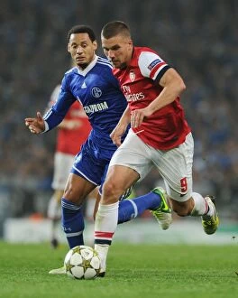 Images Dated 24th October 2012: Lukas Podolski vs. Jermaine Jones: Battle at the Emirates - Arsenal FC vs