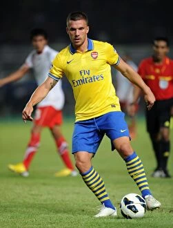 Indonesia Dream Team v Arsenal 2013-14 Collection: Lukas Podolski's Brilliant Performance: Arsenal's Victory against Indonesia All-Stars, July 2013