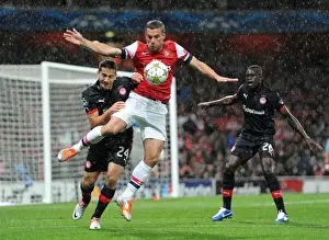 Arsenal V Olympiacos 2012-13 Prints: Lukas Podolski's Game-Winning Goal: Arsenal's Triumph over Olympiacos in the Champions League (3-1)