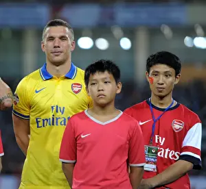 Lukas Podolski's Vietnam Adventure: The Running Man with Arsenal