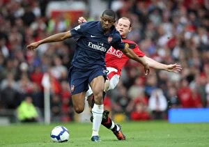 Manchester United v Arsenal 2009-10 Collection: Manchester United Edge Past Arsenal: Diaby vs. Rooney in a Tight 2:1 Battle