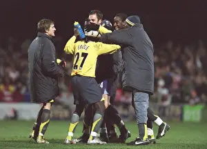 Manuel Almunia celebrates with his team mates (L>R) Arturo Lupoli, Emmanuel Eboue
