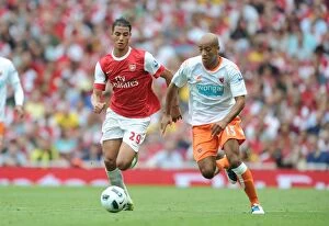 Images Dated 21st August 2010: Marouane Chamakh (Arsenal) Alex Baptiste (Blackpool). Arsenal 6: 0 Blackpool