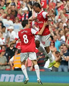 Marouane Chamakh celebrates scoring Arsenals goal with Samir Nasri