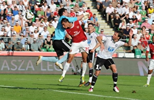 Marouane Chamakh heads past Leiga goalkeeper Marijan Antolovic to score the 1st Arsenal Marouane Chamakh heads past Leiga goalkeeper Marijan Antolovic to score the 1st Arsenal