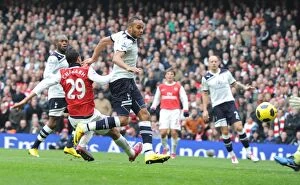 Images Dated 20th November 2010: Marouane Chamakh scores Arsenals 2nd goal under pressure from Younes Kaboul