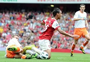 Arsenal v Blackpool 2010-11 Gallery: Marouane Chamakh is tripped by Blackpool defender Ian Evatt for the Arsenal penalty