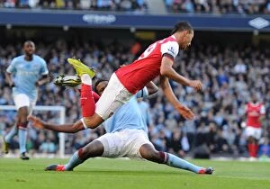 Images Dated 24th October 2010: Marouane Chamakh is tripped by Man City defender Dedryck. Manchester City 0: 3 Arsenal