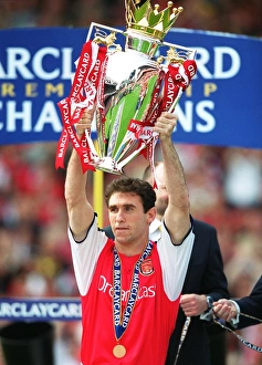 Martin Keown lifts the Premiership trophy after the match