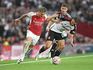 Images Dated 26th August 2023: Martin Odegaard vs. Joao Palhinha: A Premier League Battle at Emirates Stadium
