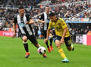 Images Dated 11th August 2019: Martinelli vs Schar: Intense Battle in Newcastle United vs Arsenal FC Premier League Clash