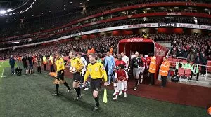 The match officials lead the team out onto the picth before the match. Arsenal 4