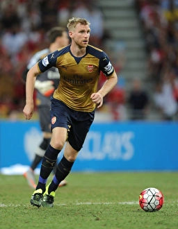 Per Mertesacker in Action: Arsenal vs. Singapore XI at Singapore National Stadium