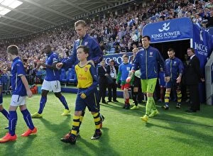 Leicester City v Arsenal 2014-15 Collection: Per Mertesacker (Arsenal) with the Arsenal Mascot. Leicester City 1: 1 Arsenal. Barclays