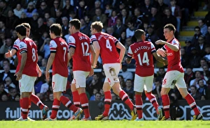Fulham v Arsenal 2012-13 Collection: Per Mertesacker celebrates scoring his goal for Arsenal with his team mates. Fulham 0: 1 Arsenal