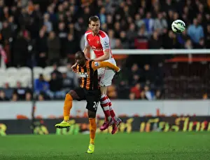Hull City V Arsenal 2014/15 Prints: Mertesacker Defends: Arsenal Star Heads Away Hull's Aluko in Intense Premier League Clash