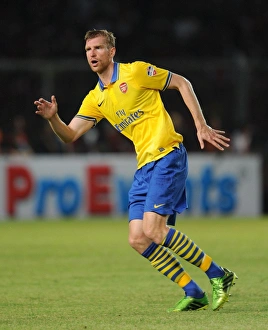 Indonesia Dream Team V Arsenal 2013-14 Prints: Per Mertesacker Faces Off Against Indonesia All-Stars in 2013