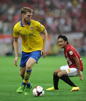 Uwara Red Diamonds V Arsenal 2013-14 Prints: Per Mertesacker Faces Off Against Shinzo Koroki in Urawa Red Diamonds vs. Arsenal Clash