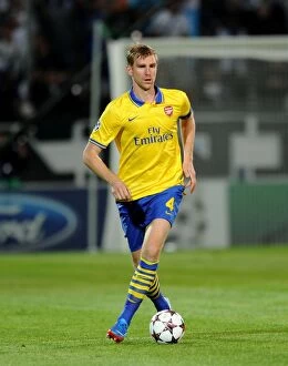 Images Dated 18th September 2013: Per Mertesacker Focuses in Marseille's Champions League Clash against Arsenal