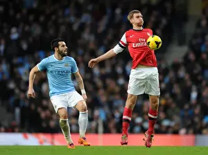 Manchester City V Arsenal 2013-14 Prints: Per Mertesacker vs. Alvaro Negredo: Intense Battle at Manchester City vs
