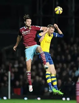 Per Mertesacker vs. Andy Carroll: Intense Battle in West Ham United vs. Arsenal Premier League Clash