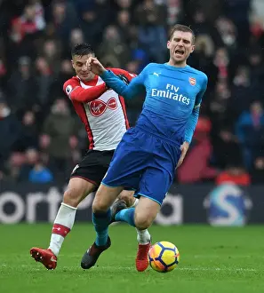 Southampton V Arsenal 2017-18 Prints: Per Mertesacker vs. Dusan Tadic: Intense Battle in Southampton v Arsenal Premier League Clash