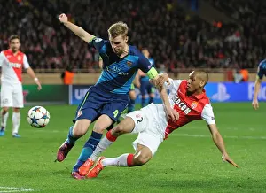 Monaco V Arsenal 2014/15 Prints: Mertesacker vs Fabinho: Intense Clash in Monaco's UCL Showdown against Arsenal