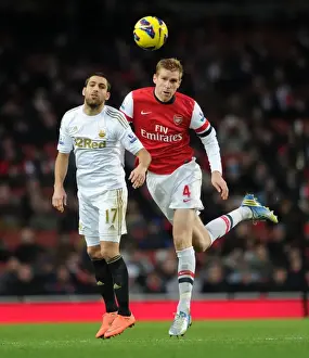 Arsenal V Swansea 2012-13 Prints: Per Mertesacker vs. Itay Shechter: Heading Clash at Arsenal vs. Swansea (2012-13)