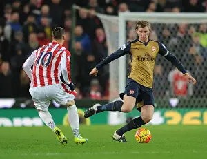 Stoke City V Arsenal 2015-16 Prints: Per Mertesacker vs Marko Arnautovic: A Footballing Battle at Stoke City