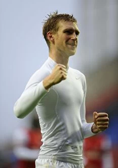 Images Dated 22nd December 2012: Per Mertesacker's Euphoric Moment: Arsenal's Victory Celebration at Wigan Athletic, 2012-13