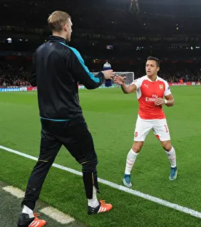 Arsenal V Olympiacos 2015/16 Prints: Mertesacker's Support: Alexis Sanchez Receives Water Bottle from TeamMate During Arsenal vs